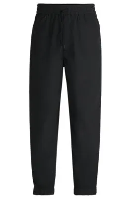 Pantalones relaxed fit en tejido ligero repelente al agua